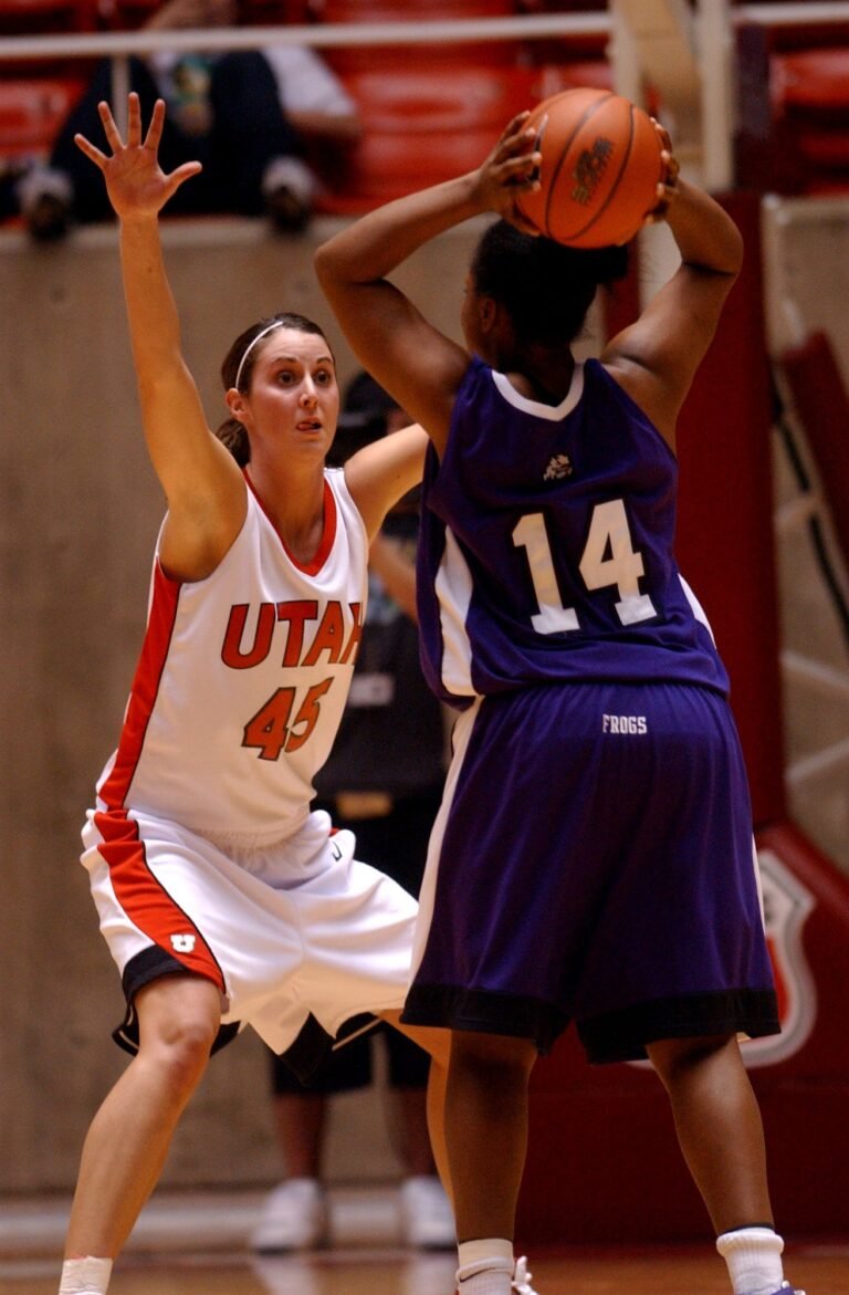 Jessica defending during a basketball game in her Utah uniform